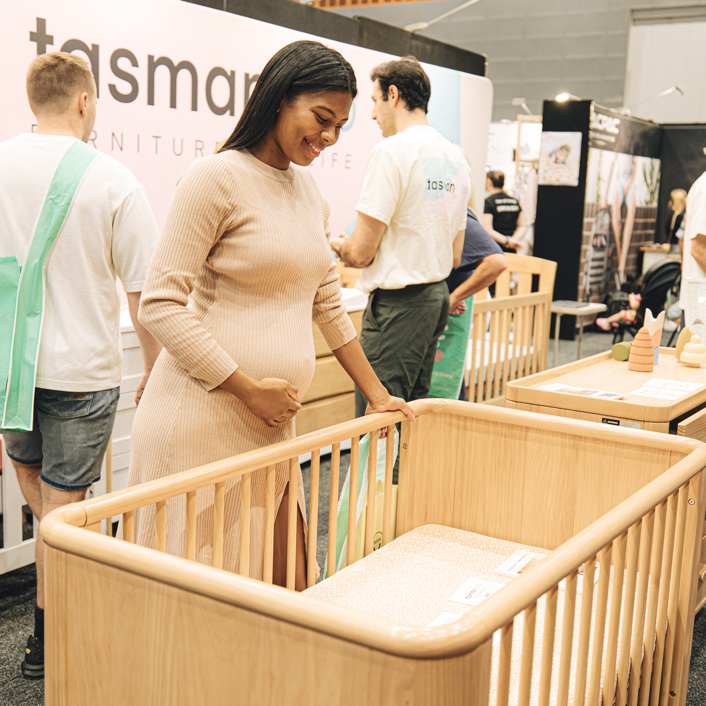 Pregnant woman is trying a baby cot